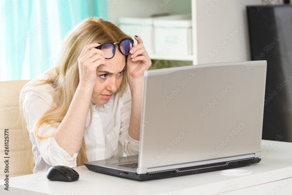 Portrait of smart female manager in glasses typing on laptop. Portrait of smart female manager in glasses typing on laptop.