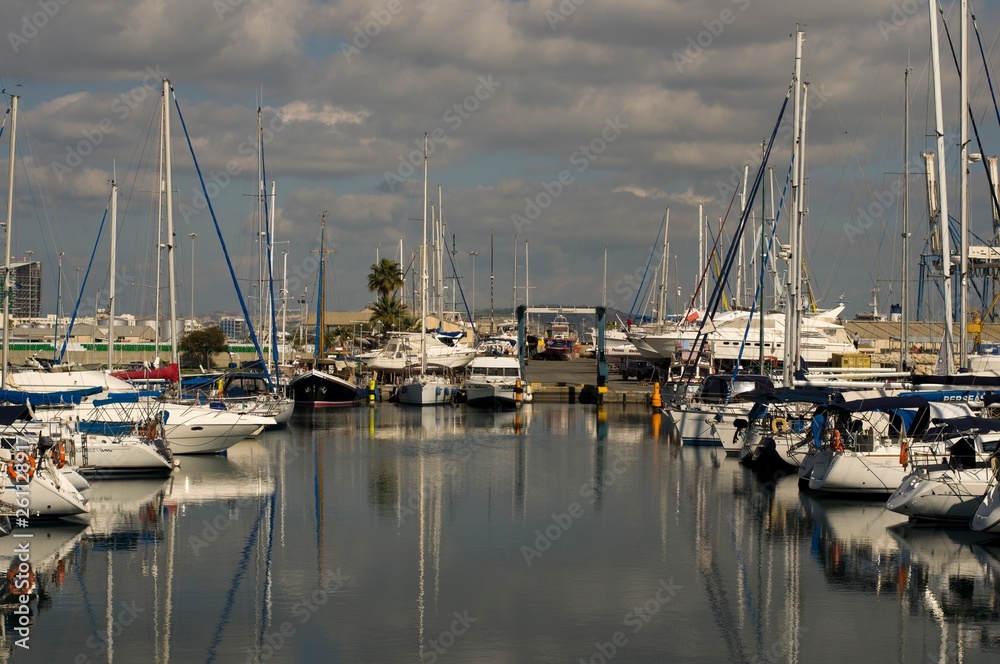 Landscape of a marina in Cyprus with cloudy sky and water reflections 