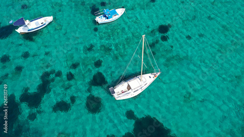 Aerial drone bird's eye view photo of sail boats docked in tropical caribbean paradise bay and turquoise clear sea © aerial-drone