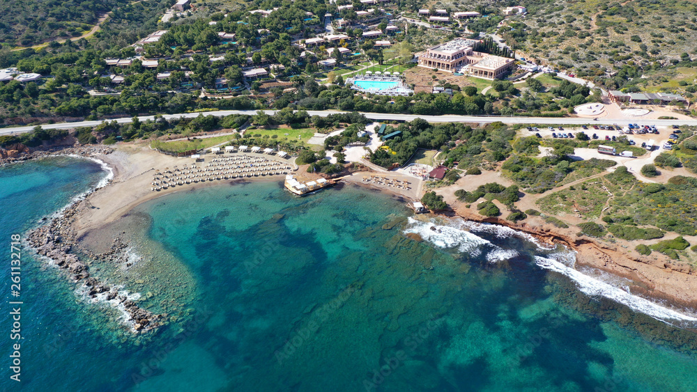 Aerial top view photo of sun beds in tropical paradise deep emerald mediterranean sandy beach