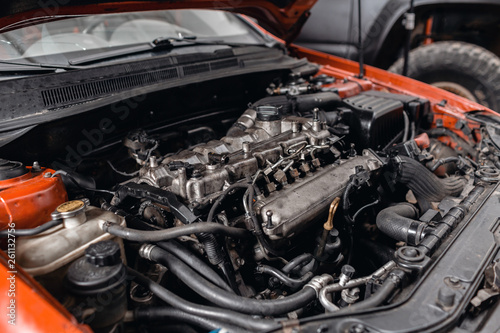 Close-up of the diesel engine of the car. The master repairs the car in the garage. Car service for repair of vehicles