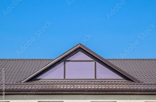 House with plastic windows and a brown roof of corrugated sheet © eleonimages