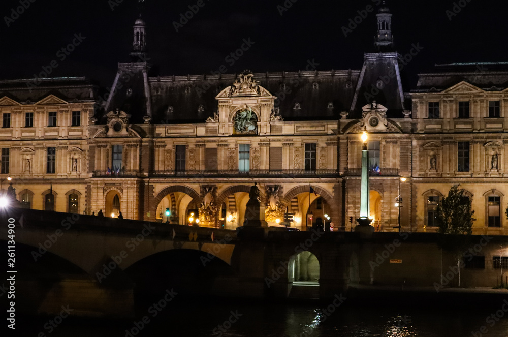 Historic building of Paris and bridge over the River Seine at the night. France