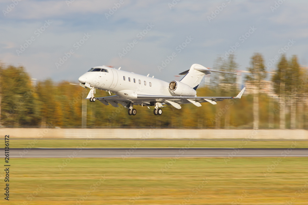 White private jet plane taking off, trees on background, copy space, in motion. Starting airplane. Business aviation, successful life concept White private jet plane taking off, trees on background, copy space, in motion. Starting airplane. Business aviation, successful life concept
