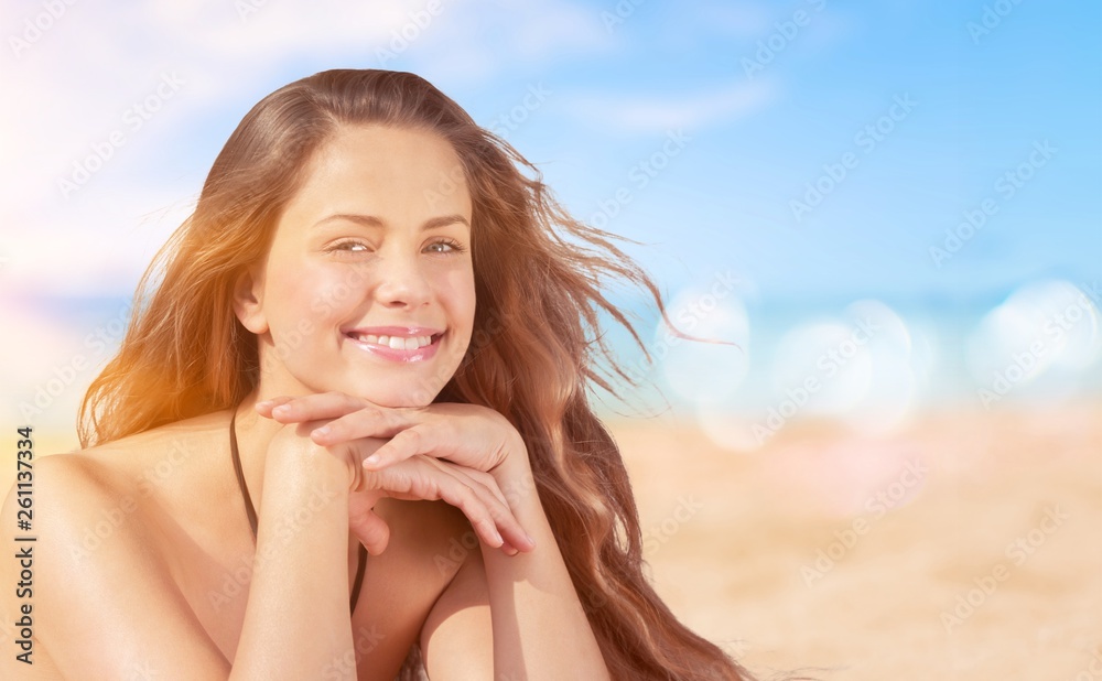 Outdoor summer portrait of pretty young smiling happy woman posing