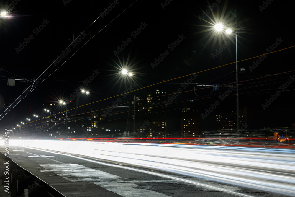 long exposure of lights on road at night near buildings long exposure of lights on road at night near buildings