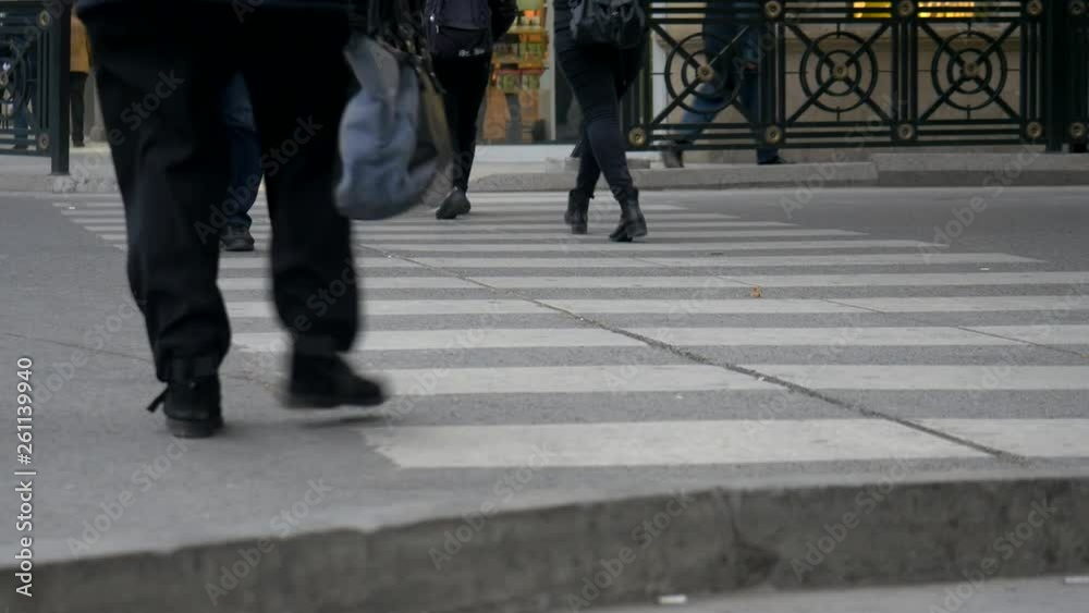 Medium shot of people walking through a crosswalk in the city. Medium shot of people walking through a crosswalk in the city.