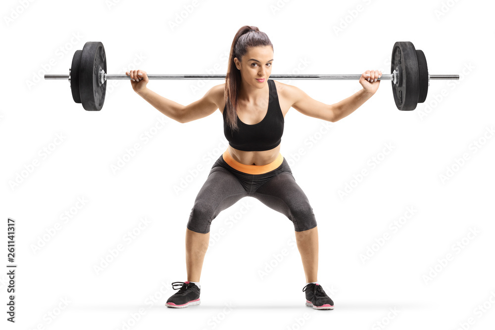 Obraz premium Young female athlete lifting weigths