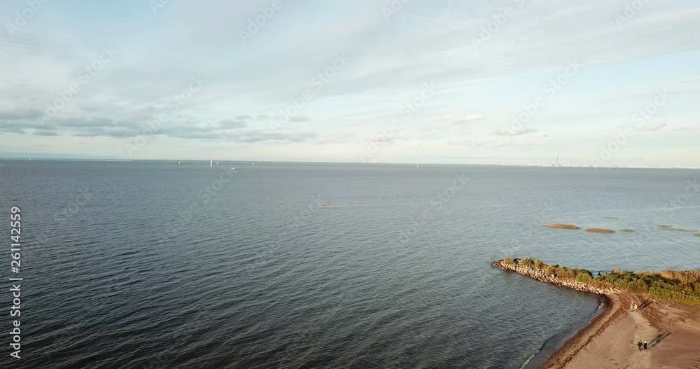 View from the drone on the sandy beach and the coast of the Gulf of Finland, on the horizon the districts of St. Petersburg View from the drone on the sandy beach and the coast of the Gulf of Finland, on the horizon the districts of St. Petersburg