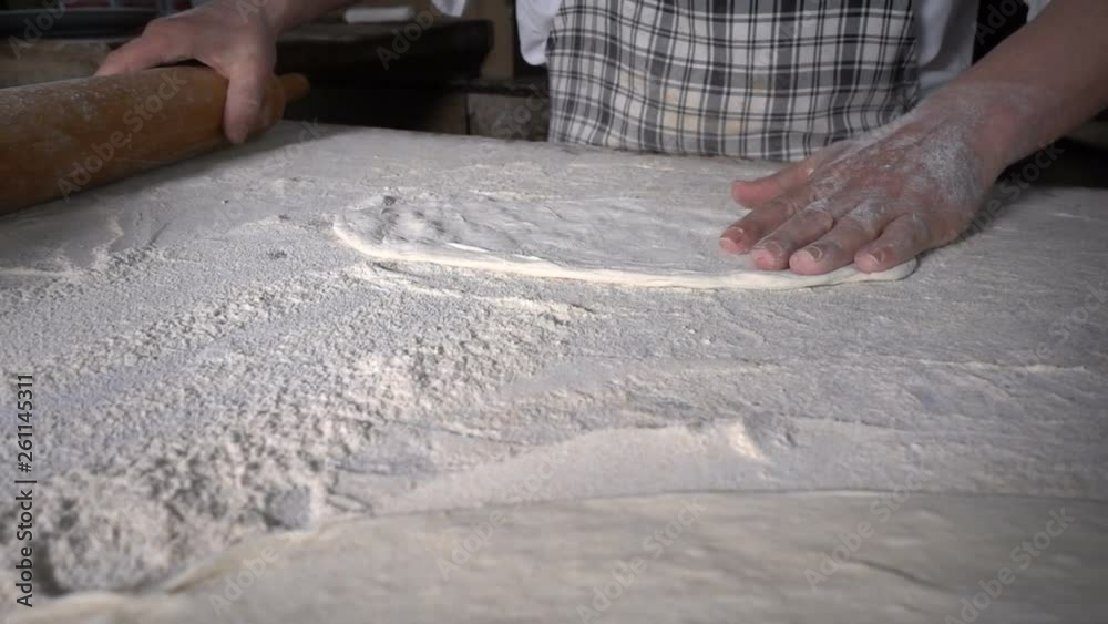 Rolling Out Dough with Flour to Make Turkish Pita Rolling Out Dough with Flour to Make Turkish Pita