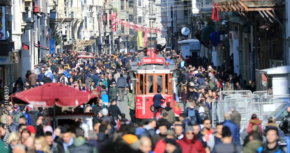 ISTANBUL, TURKEY- JANUARY 7, 2019 :  A view of crowded walking on famous Taksim Istiklal Avenue at winter time