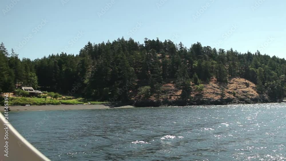 View From A Ferry as It Sails Past A Rocky, Tree Covered Island View From A Ferry as It Sails Past A Rocky, Tree Covered Island