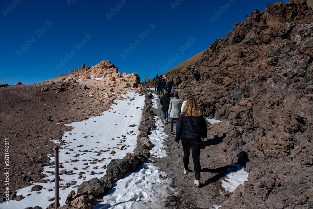 Rear view of tourists hiking on top of Teide volcano
