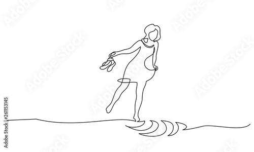 Woman walking on water with shoes in her hands