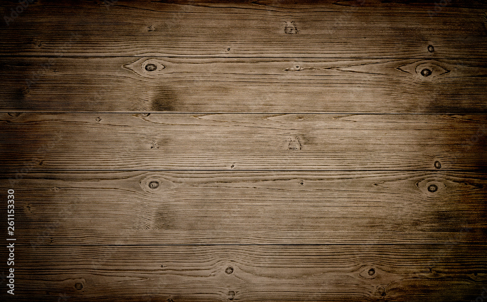 Naklejka premium Warm brown wood surface with aged boards lined up. Wooden planks on a wall or floor with grain and texture. 