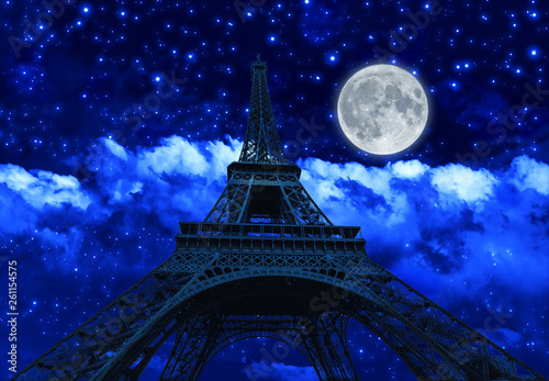 night sky with clouds and big full moon at night with backlit Eiffel Tower. Paris in France.