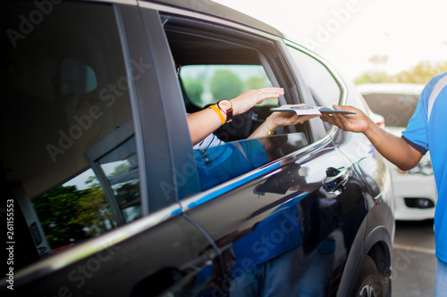 Selective focus to passenger woman pay credit card with staff for fuel in gas station.