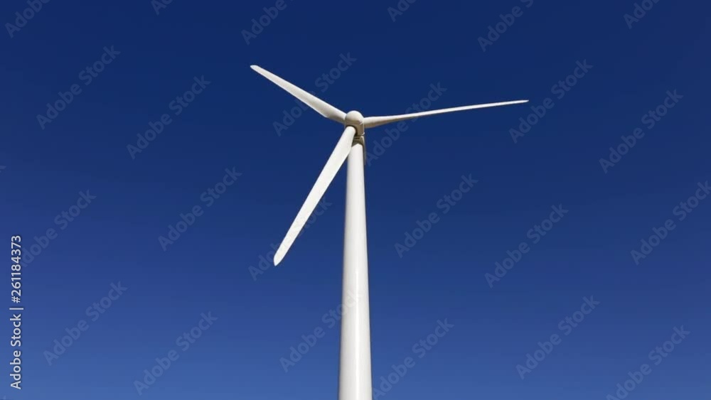 Close-up view of giant wind turbine rotating in strong winds. Energy production of clean and renewable source. Close-up view of giant wind turbine rotating in strong winds. Energy production of clean and renewable source.