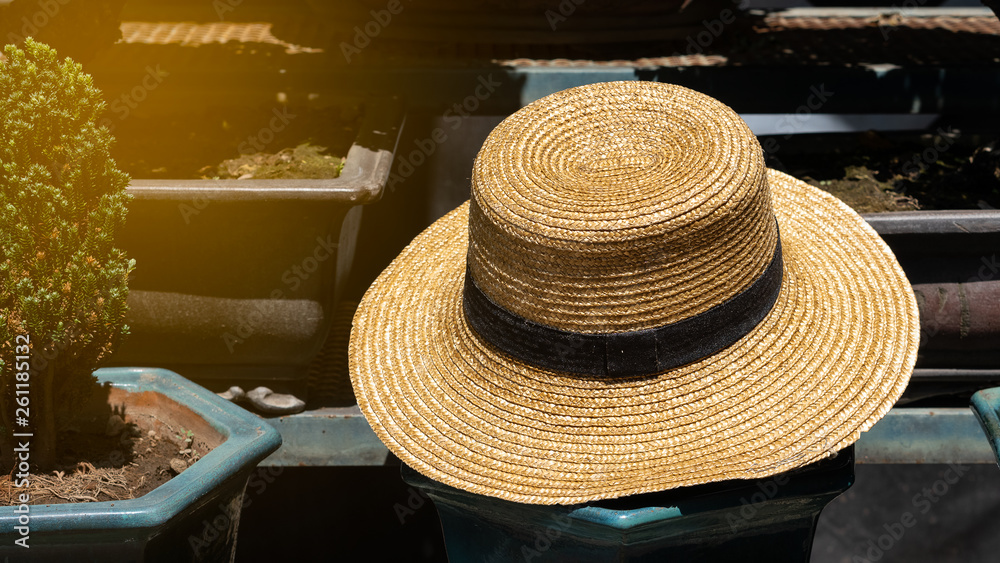 Straw hats are placed outdoors.