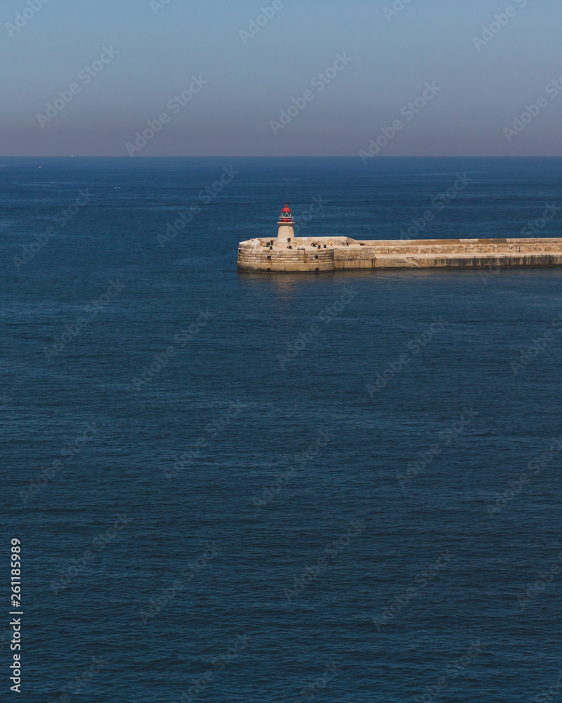 Lighthouse over water from Valletta, Malta