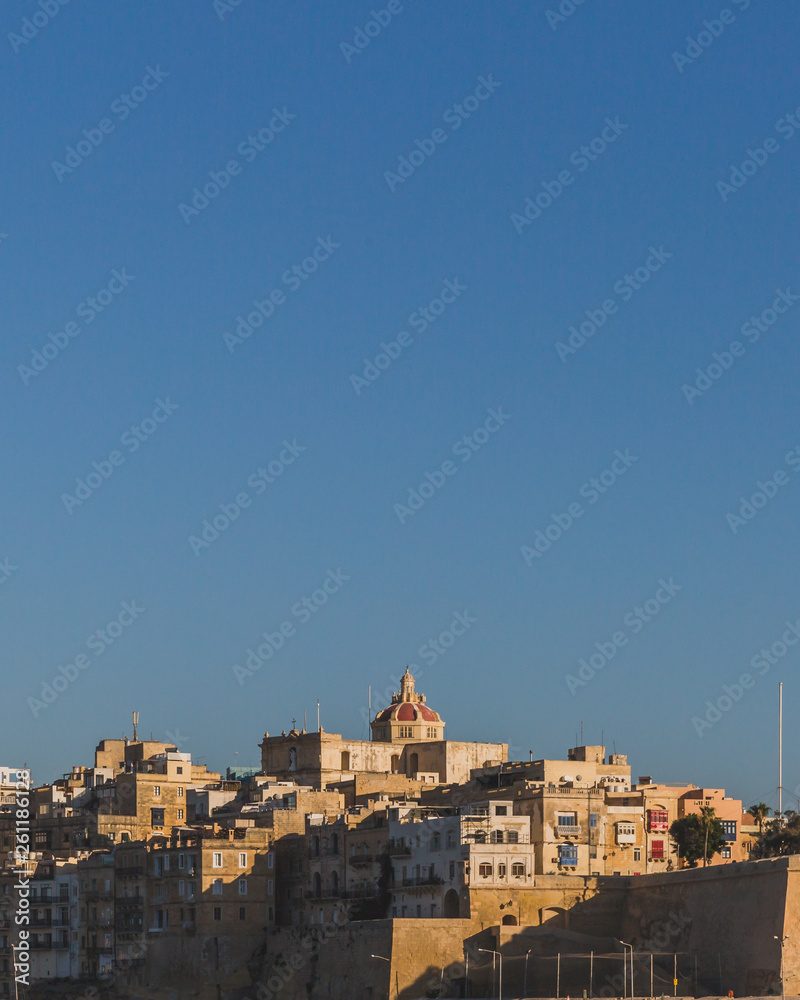 City of Senglea, Malta under blue sky, with St.Phillip's Church