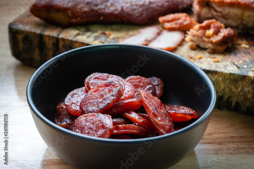 sliced chinese sausage in black bowl