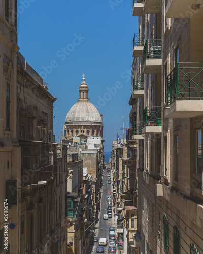 Streets and buildings in downtown Valletta, Malta, with dome of Basilica of Our Lady of Mount Carmel