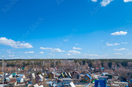 Aerial drone view of an old traditiona village in the forest, on background bly sky.
