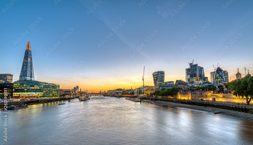 Sunset at the river Thames in London with the skyscrapers of the City