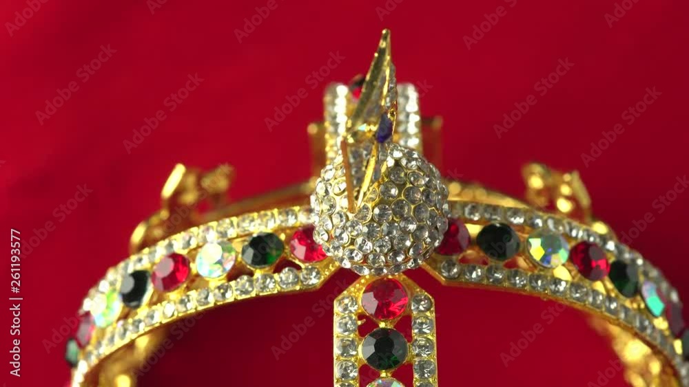 Gold diamond crown or decorative pageant accessory close up focus on the bottom frame. Slowly rotation on the red royal color surface. 4k, uhd. Gold diamond crown or decorative pageant accessory close up focus on the bottom frame. Slowly rotation on the red royal color surface. 4k, uhd.