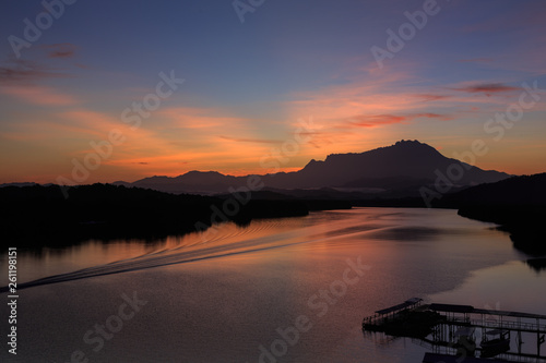 Fototapeta Naklejka Na Ścianę i Meble -  Amazing Beautiful Twilight Sunrise with Rays of light and Mount Kinabalu as background at Gayang, Tuaran, Sabah, Borneo