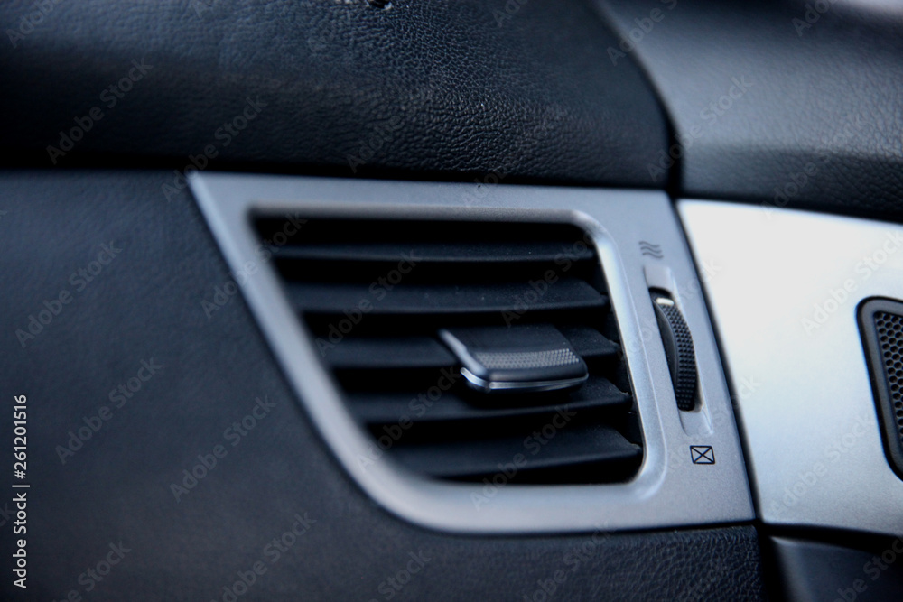 Air ducts, deflector panel with switch in the car. Car conditioner. The air flow inside the car.