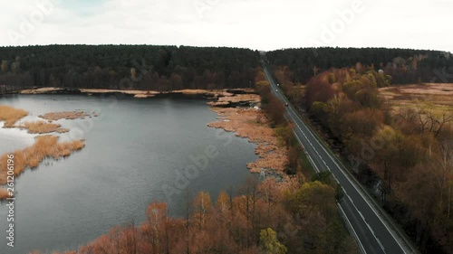 Aerial shot of field flooded by the lake next to the road, Aerial shot of field flooded by the Bachotek lake next to the road to Brodnica city photo