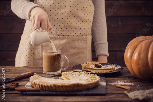 woman with cup of coffee and pumpkin pie