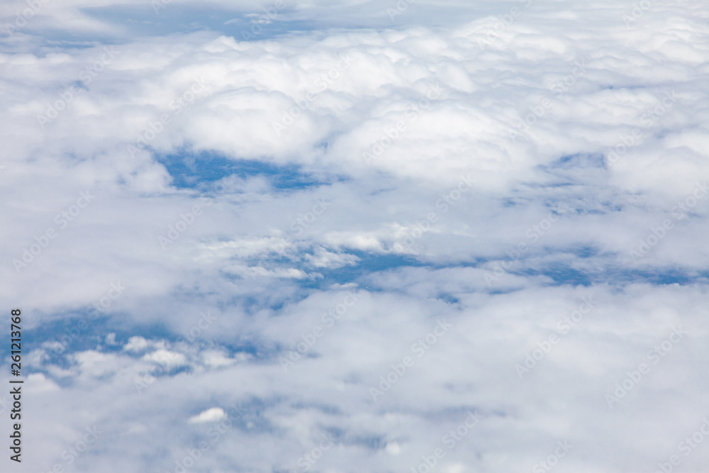 Clouds, sky and ground, looking from the plane.