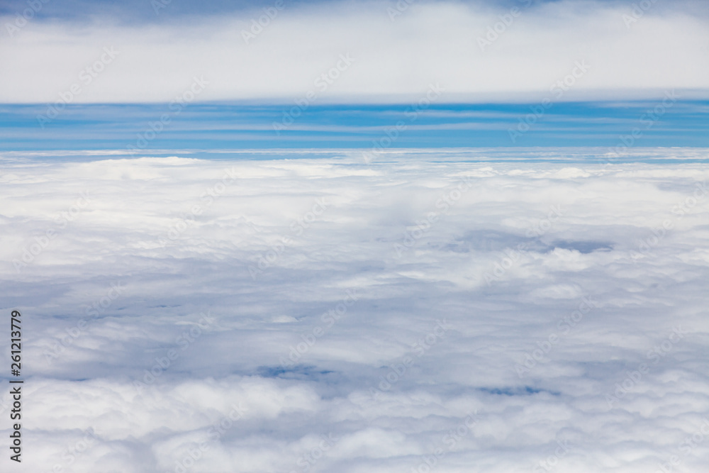 Clouds, sky and ground, looking from the plane.