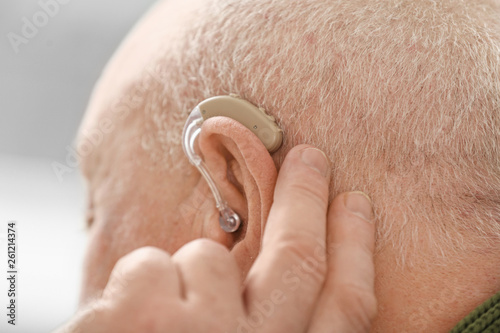 Senior man with hearing aid...