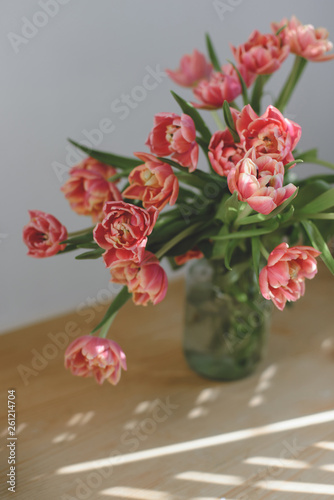Pink peony tulips in a glass jar. © Elena