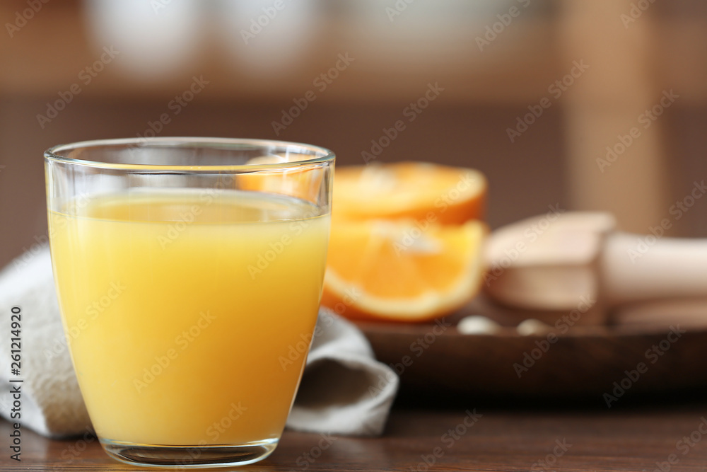 Glass of freshly squeezed orange juice on table Glass of freshly squeezed orange juice on table