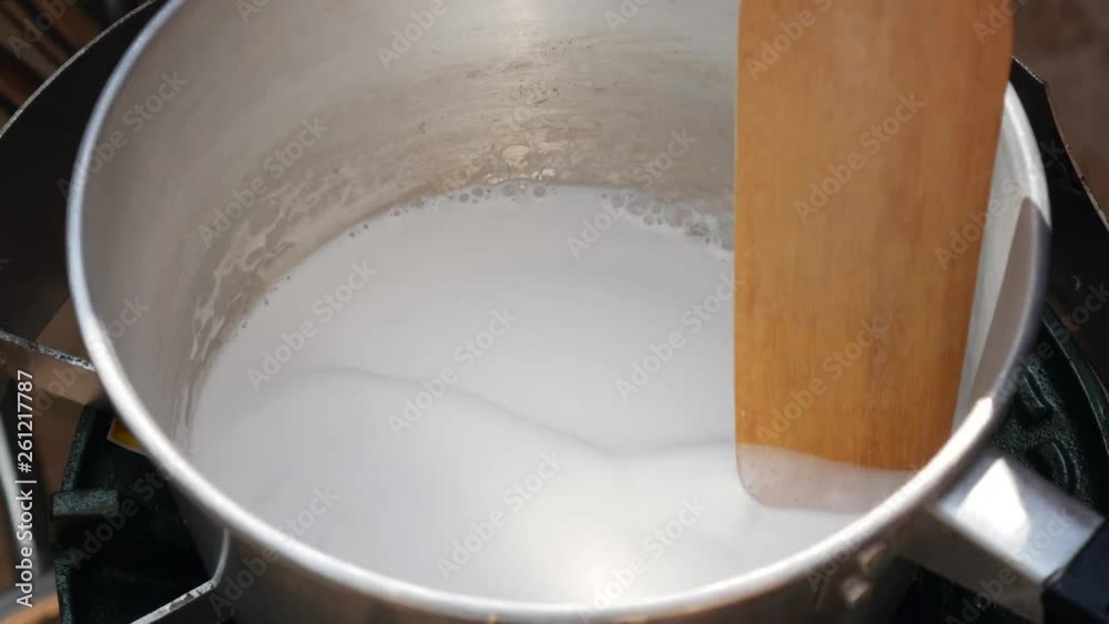 Pour coconut milk in a pot. Step by step cooking tom yam soup. Thai cuisine. Closeup. 4k Pour coconut milk in a pot. Step by step cooking tom yam soup. Thai cuisine. Closeup. 4k