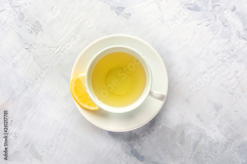 A photo of a cup of tea with lemon, shot from the top with copy space