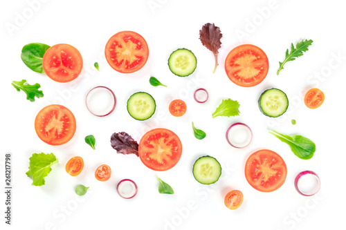 Fresh vegetable salad ingredients, shot from the top on a white background. A flat lay composition with tomato, cucumber, onion slices and mezclun leaves