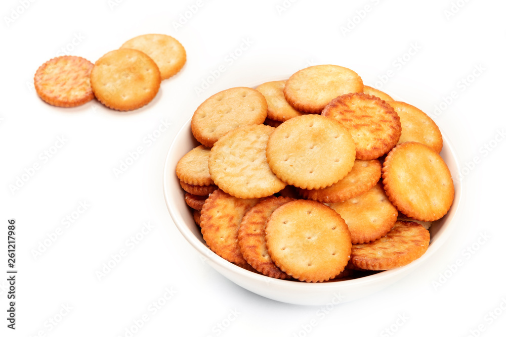Salt crackers in a bowl on a white background with copy space