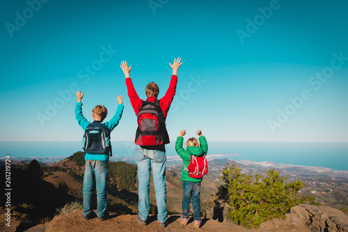 happy father and kids enjoy travel hiking in mountains