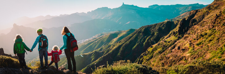 Mother with kids travel in mountains, family hiking in nature