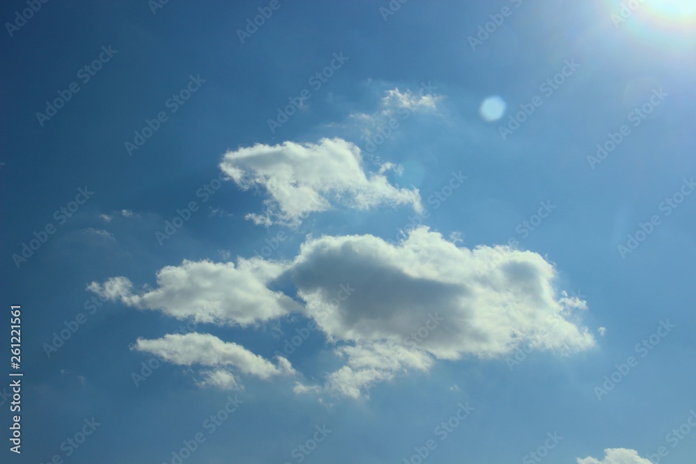 World-outlook. Many small clouds in the light of the sun in the spring sky. Spring bright blue sky with small clouds in the sun rays. Breathing in the fresh air, you feel the approach of spring.