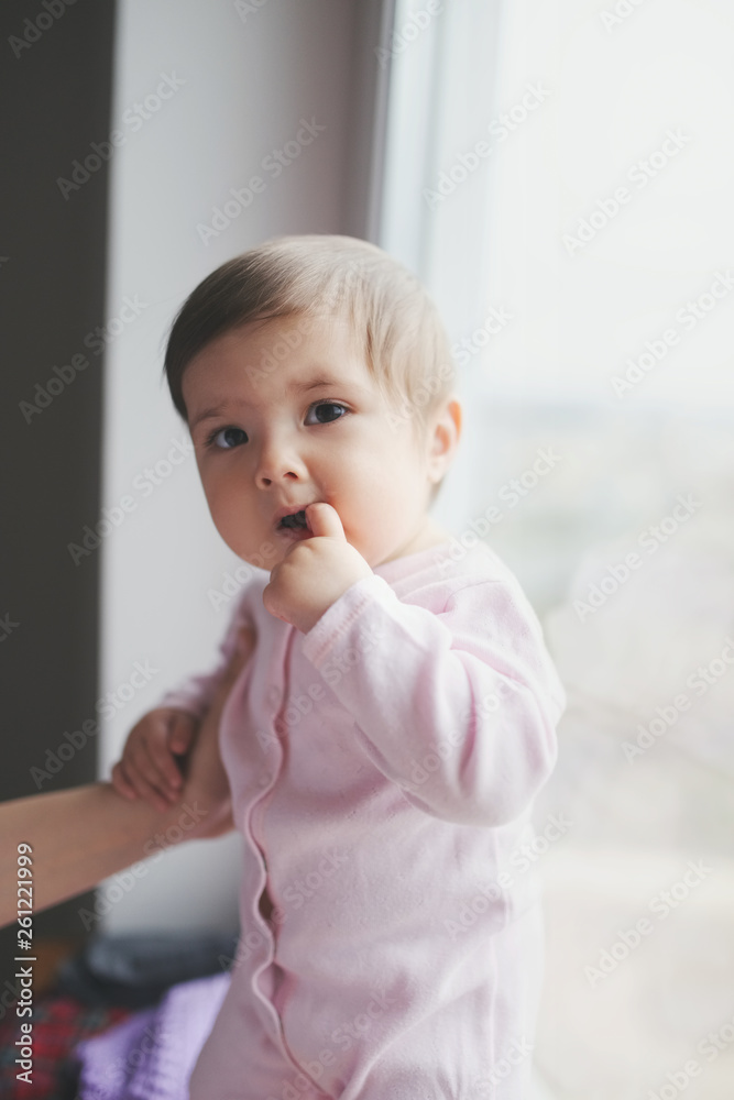cute happy baby with finger in mouth
