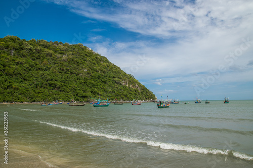 Thai traditional wooden longtail boat and beautiful sand beach 