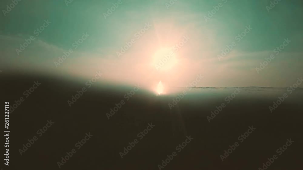From the surface of the water to the underwater sunbeam light and rays with wave movement of the sea ripple From the surface of the water to the underwater sunbeam light and rays with wave movement of the sea ripple