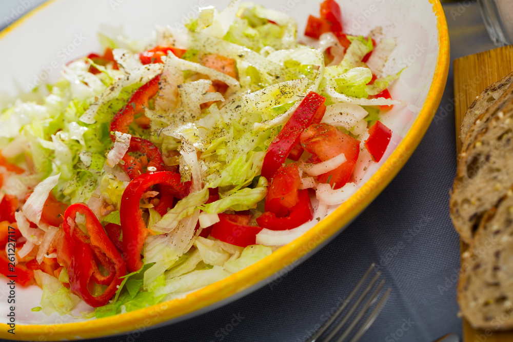 Summer vegetable salad - red bell peppers, lettuce and onions